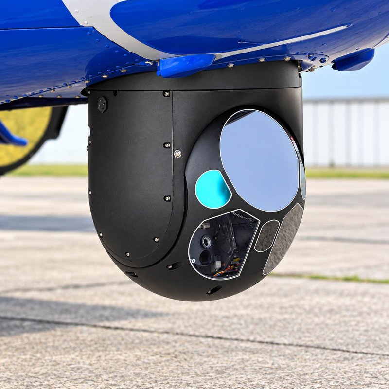 Aircraft-mounted optical sensor beneath a blue fuselage