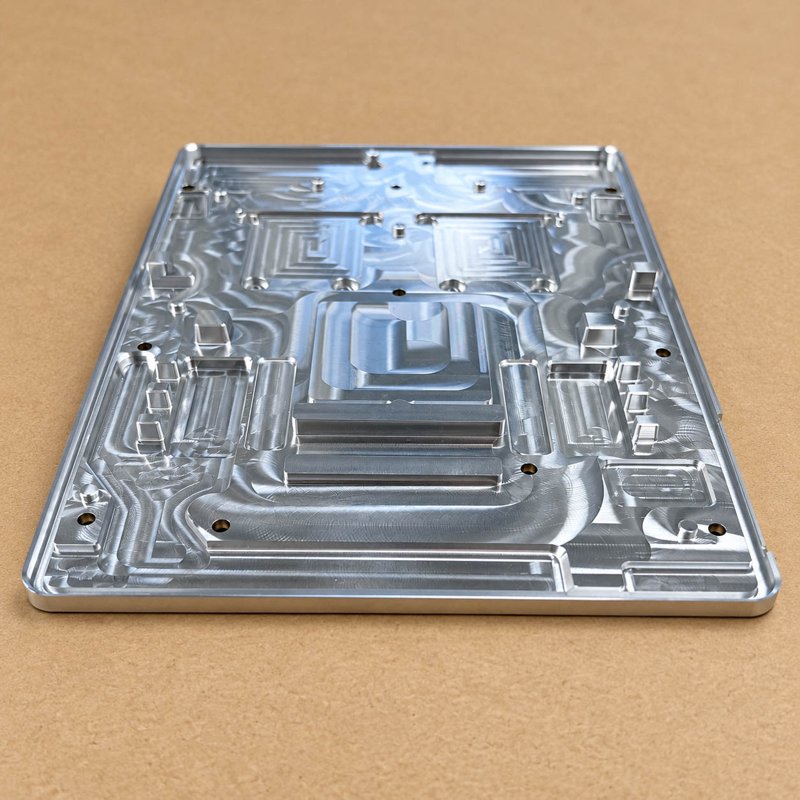 Rectangular aluminum plate with intricate machined channels